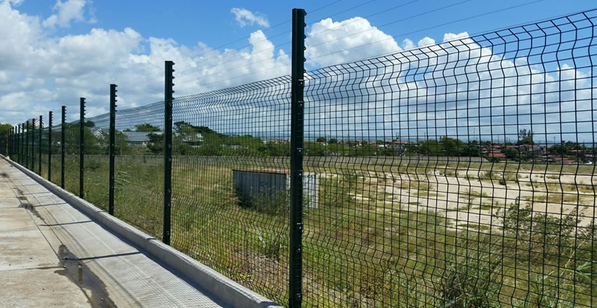 Green low Security clear view fence with line wire topping is used for road fencing, separating the road from grassland.