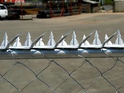 Wall spikes are installed at the top of the chain link fencing.